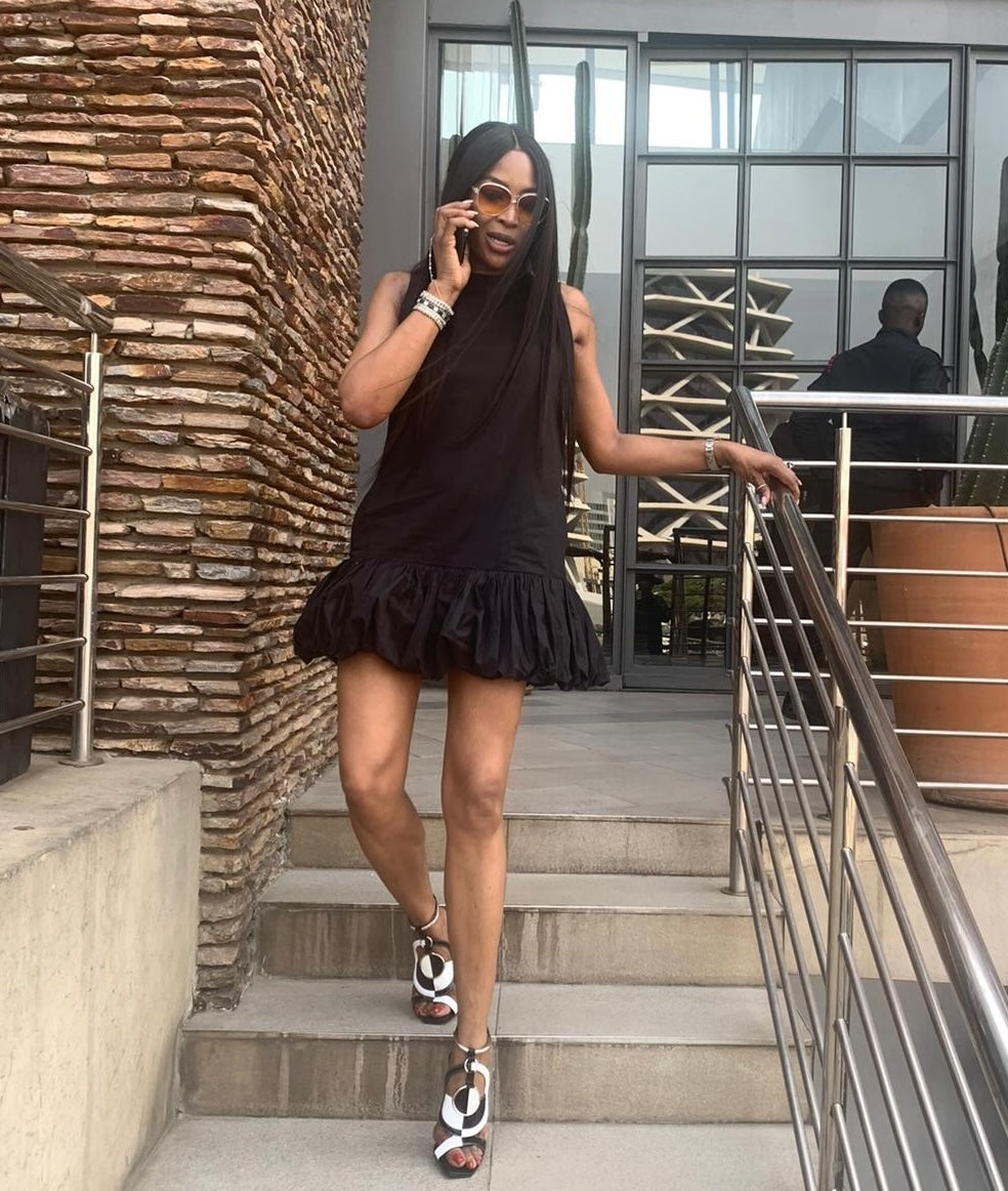 Naomi Campbell is a short babydoll dress by Room502