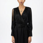 Woman wearing a black dress against a white background