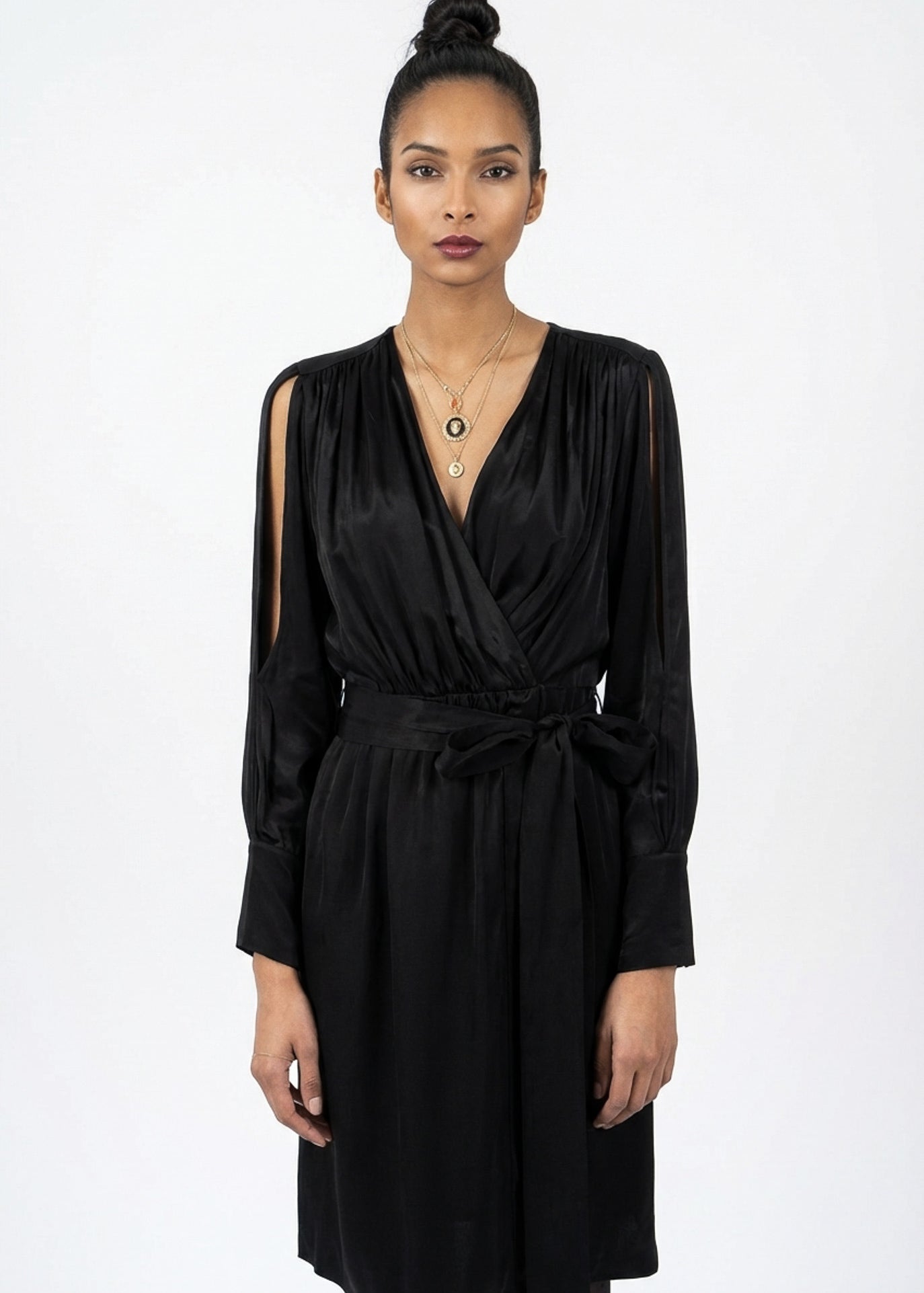 Woman wearing a black dress against a white background