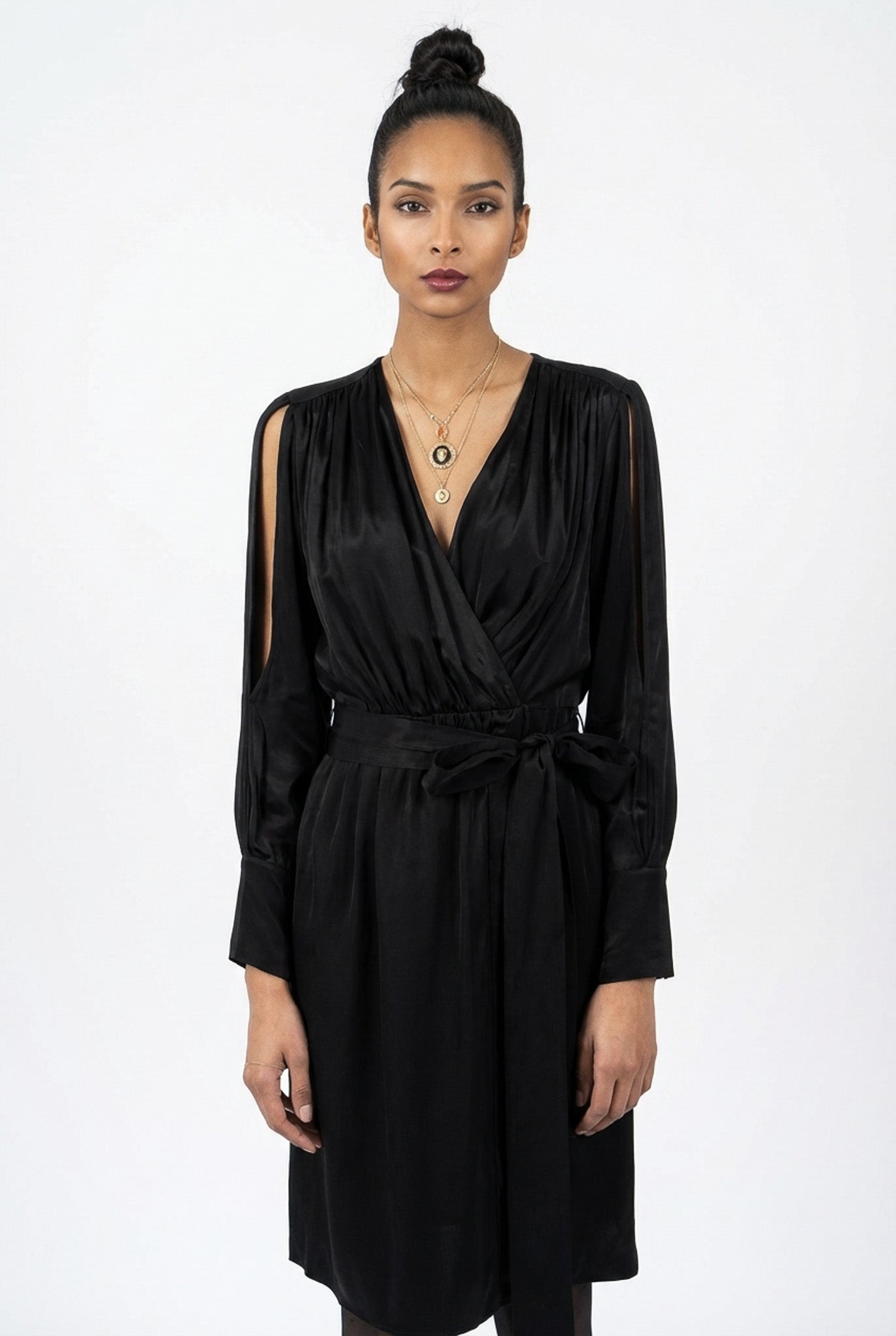 Woman wearing a black dress against a white background