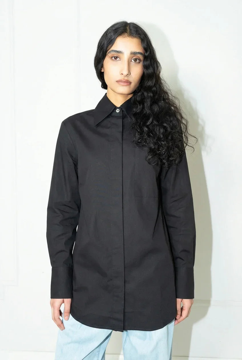 Woman wearing a black shirt against a white background