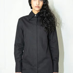 Woman wearing a black shirt against a white background