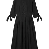Black shirtdress with button details on a white background
