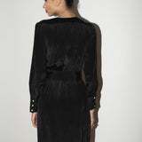 Woman wearing a black silk dress against a white background