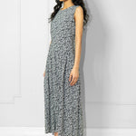 Woman wearing a Room502 black and white patterned dress against a white background